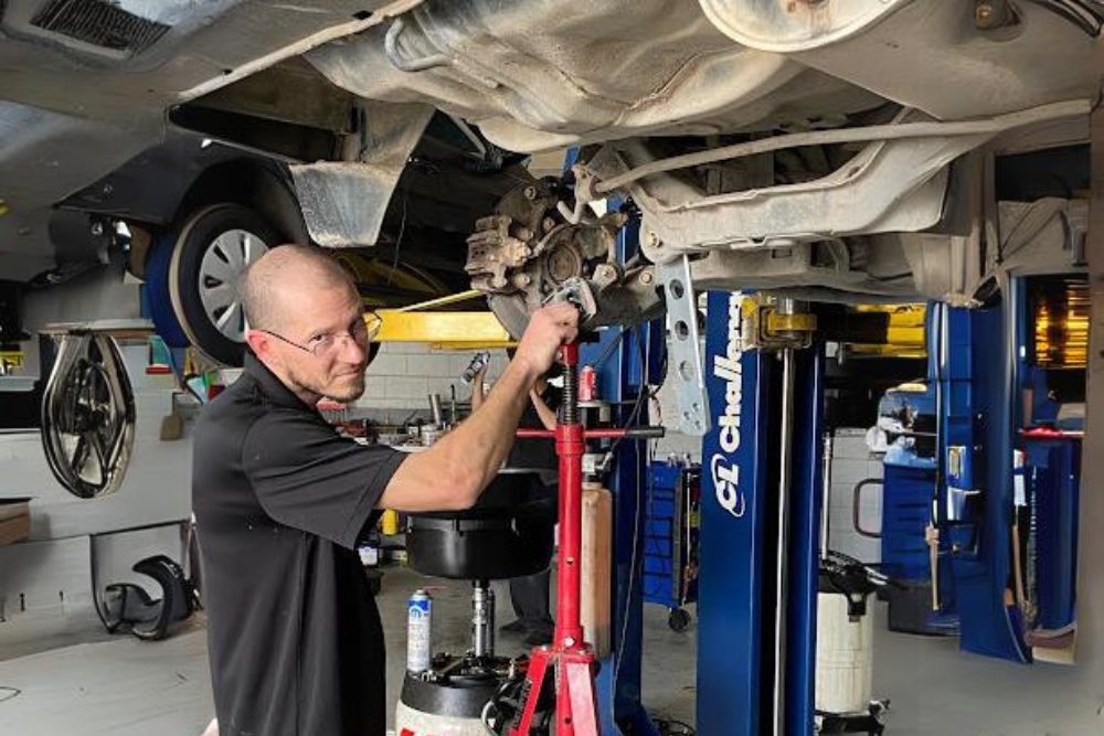 Brake fluid flush service near me in Groveland, FL with Griffis Automotive Clinic. Image of mechanic performing a brake fluid flush on a vehicle that came into the shop for brake services.