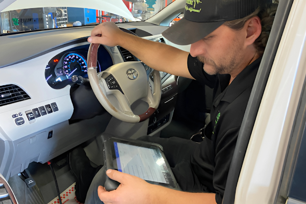 auto diagnostics, auto repair in Groveland, FL at Griffis Automotive Clinic, Inc. An automotive technician performing a diagnostic scan on a Toyota vehicle.