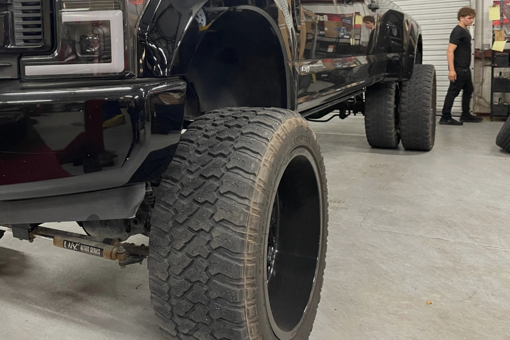 Fall Tire Inspection In Groveland, FL At Griffis Automotive Clinic. Close-up of vehicle tire during inspection at auto repair shop