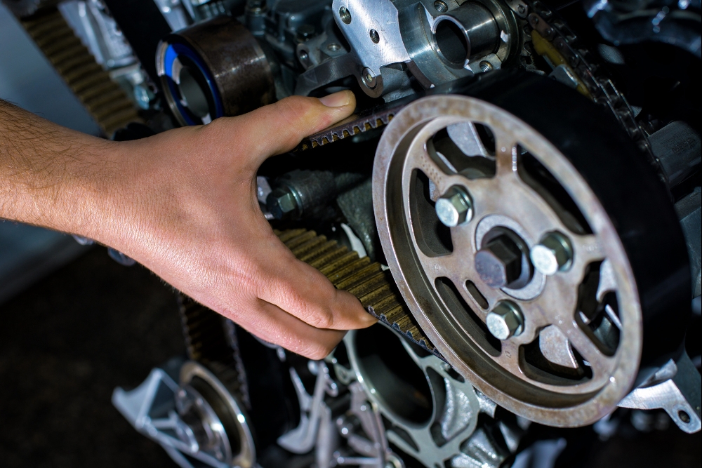 Holiday Break Downs Timing Belt Service in Groveland, FL At Griffis Automotive Clinic. Close up view of timing belt in auto repair shop
